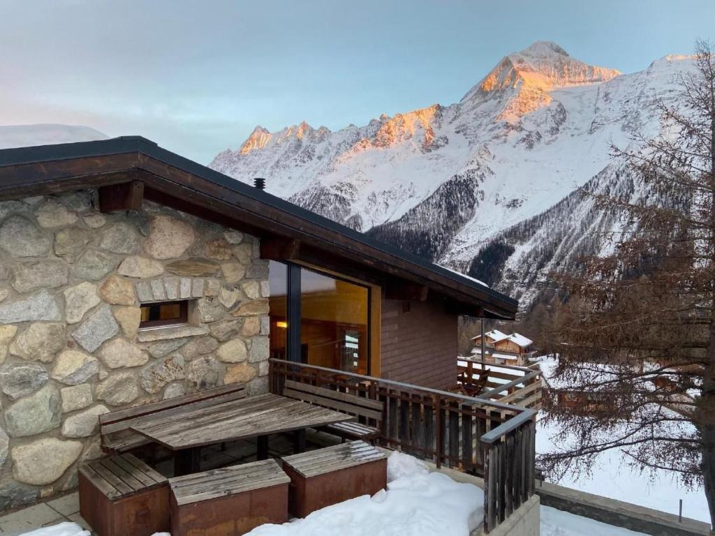 a house with a balcony with a mountain in the background at Apartment Hockenhorn by Interhome in Wiler