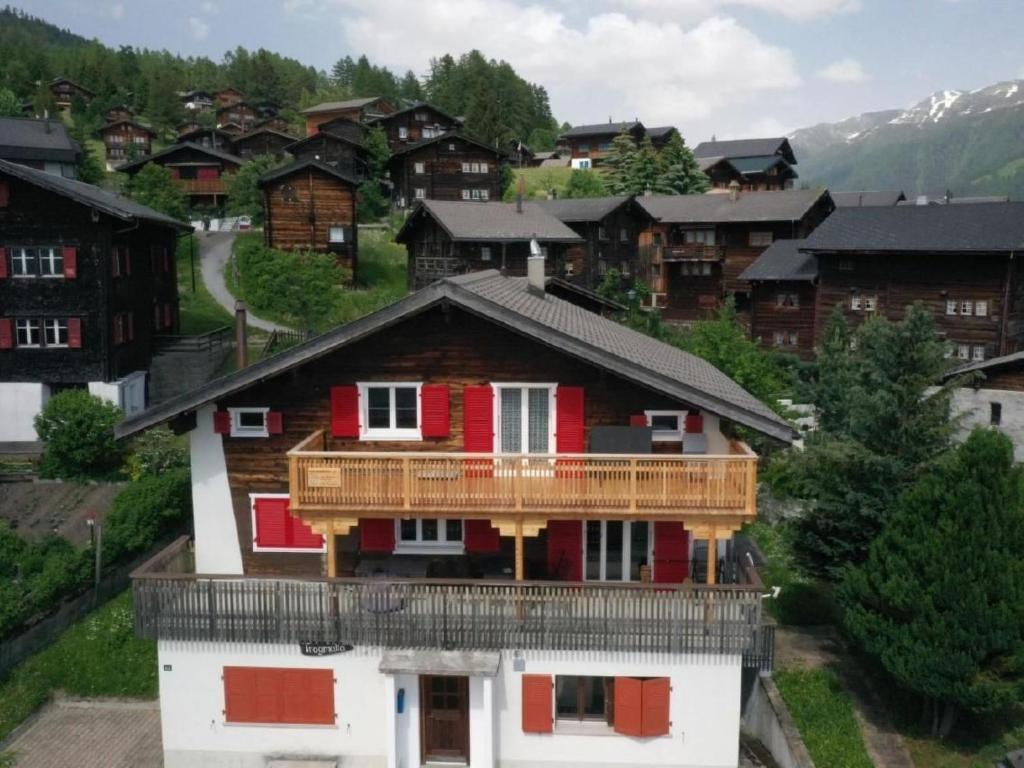 a house with a balcony on top of it at Apartment Alter Konsum by Interhome in Bellwald