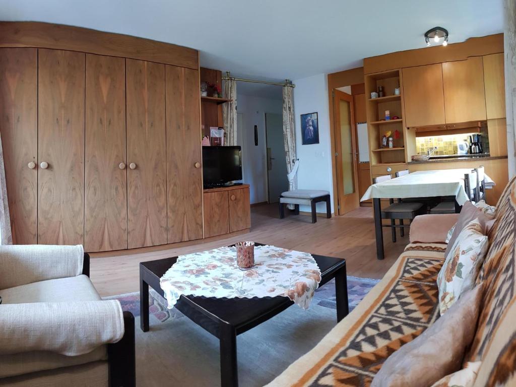 a living room with a couch and a table at Apartment Royal 22 nahe Klinik- Burgerbad- Einkaufszentrum by Interhome in Leukerbad
