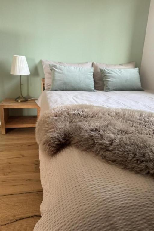 a bedroom with a bed with a brown blanket at Apartment Sunnehöckli by Interhome in Hasliberg