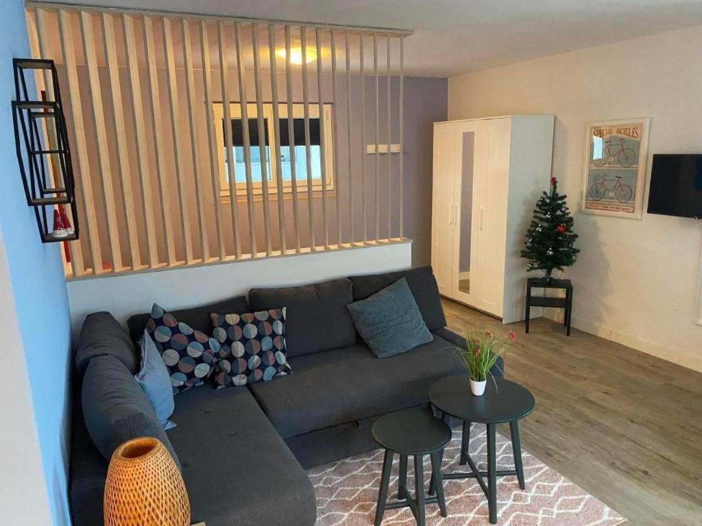 a living room with a couch and a table at Apartment Spring Inn Studio by Interhome in Rohrmatten