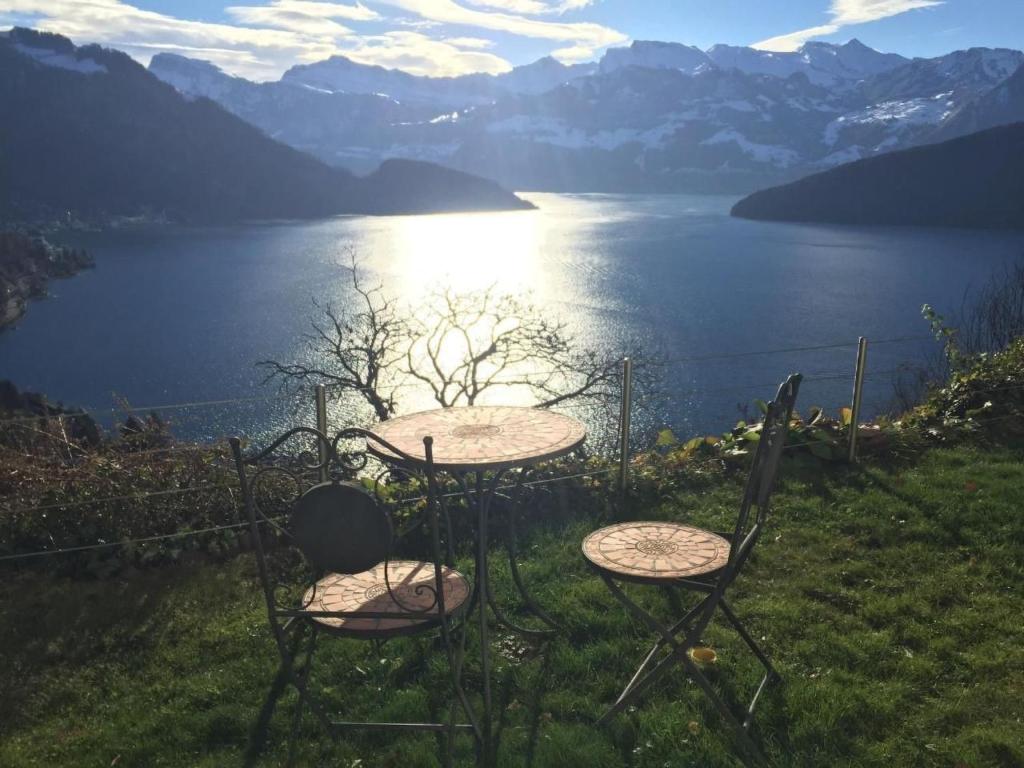 two chairs and a table with a view of a lake at Apartment Weggis by Interhome in Weggis