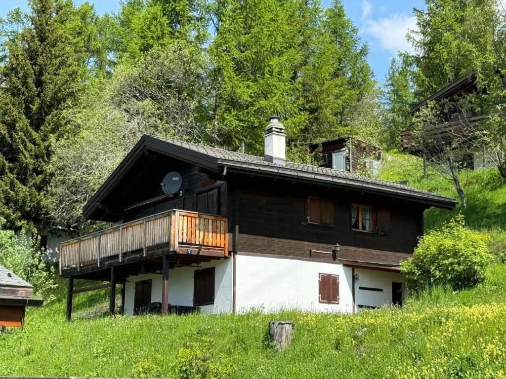 a house with a balcony on the side of it at Holiday Home Chalet Glücksfall by Interhome in Bellwald
