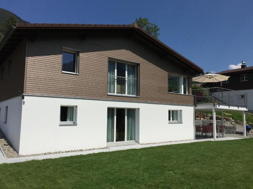 a house with white walls and a brown roof at Apartment Saturn by Interhome in Sörenberg