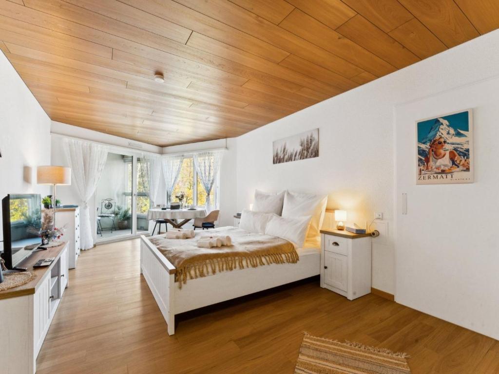 a bedroom with a bed and a wooden ceiling at Apartment Lake View Studio by Interhome in Ingenbohl