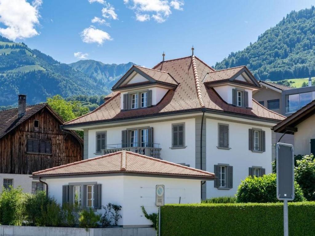 a large white house with a tiled roof at Holiday Home Verena's B&B by Interhome in Sachseln