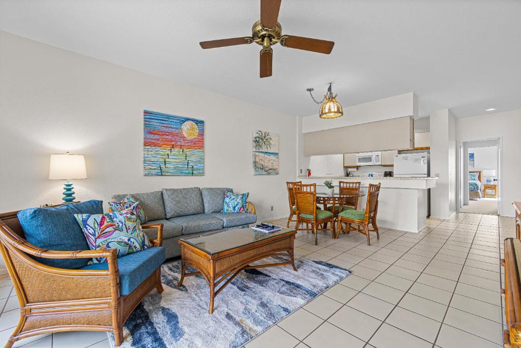 a living room with a couch and a table at Grand Champions 033 in Wailea