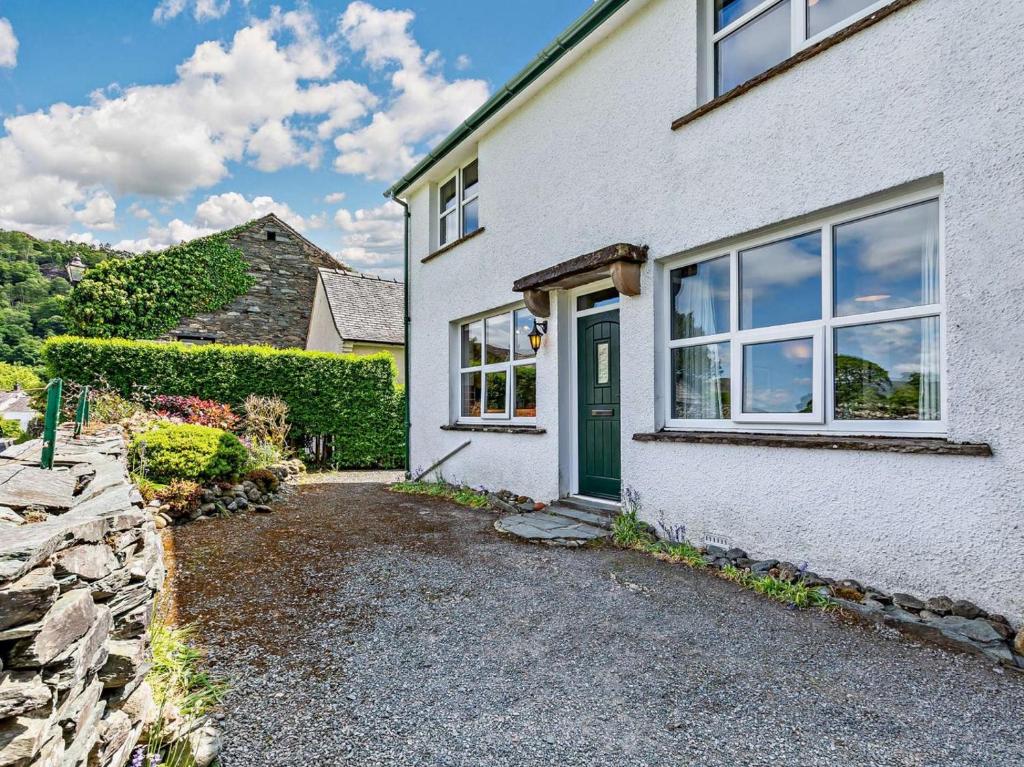 a white house with a green door at 3 Bed in Keswick oc-sz148 in Grange