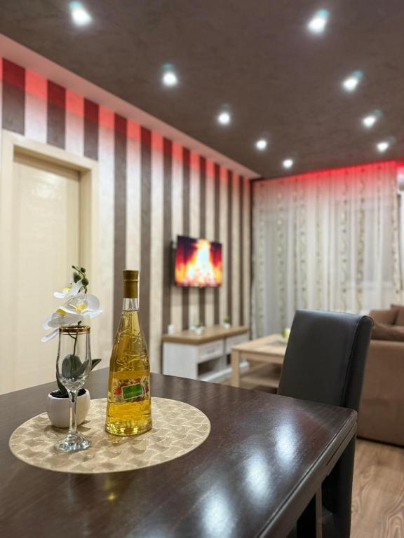 a bottle of wine on a table in a living room at Perisic Apartman Obrenovac, sa parkingom in Obrenovac