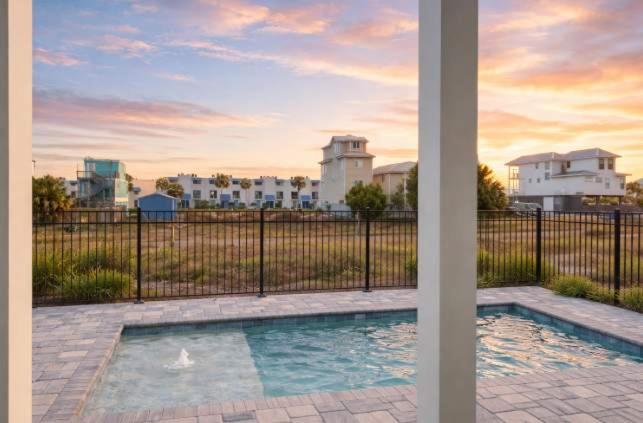 a swimming pool in front of a fence at New- Prime Location - Ground Floor Bedroom - Pool in Eastpoint