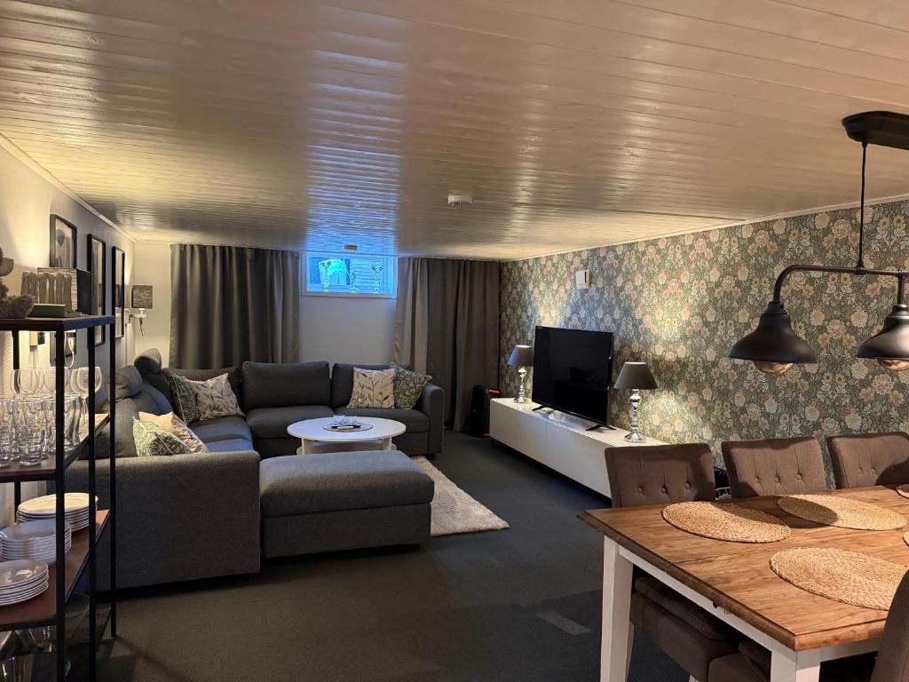 a living room with a couch and a table at Gamletull Guesthouse in Halmstad