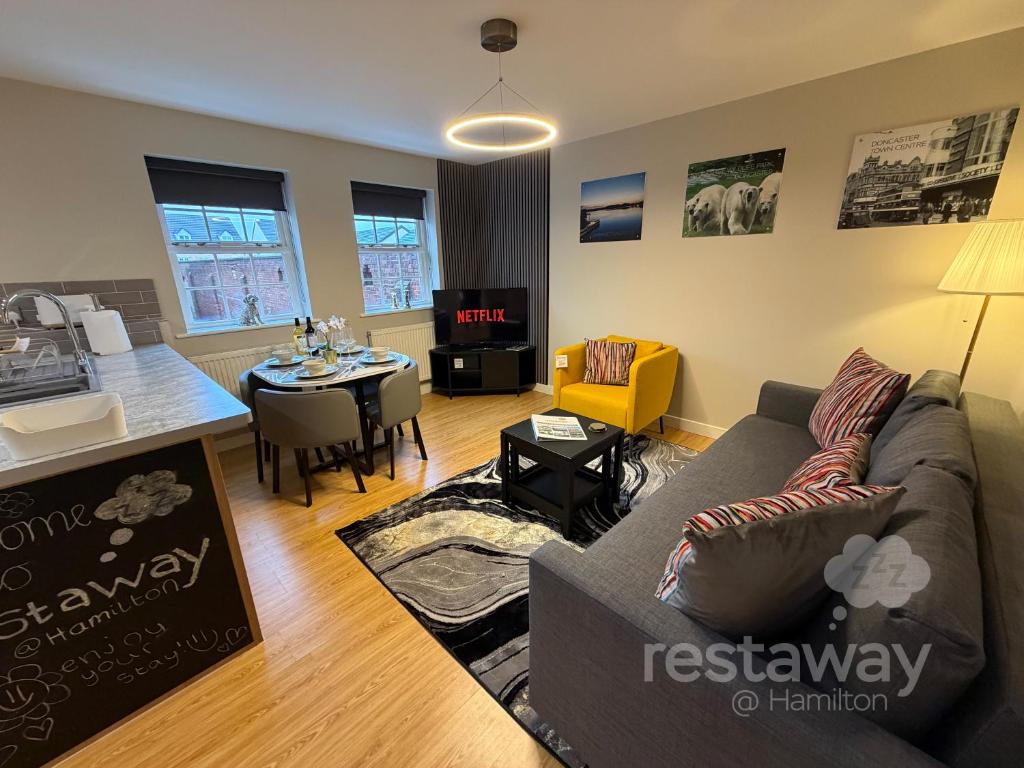 a living room with a couch and a table at restaway at Hamilton in Doncaster