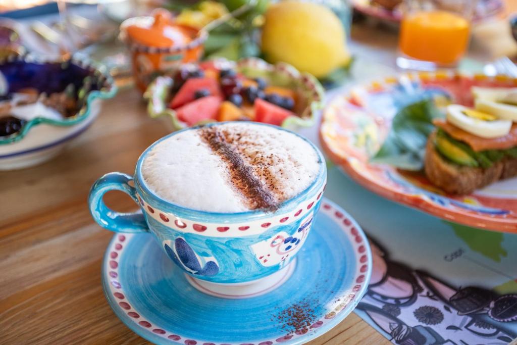a cup of coffee on a table with plates of food at Rosaria casaventre in Vietri sul Mare