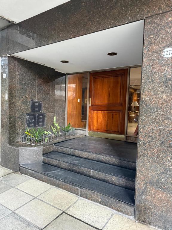 a building with stairs leading to a door at Apartamento Belgrano in Buenos Aires