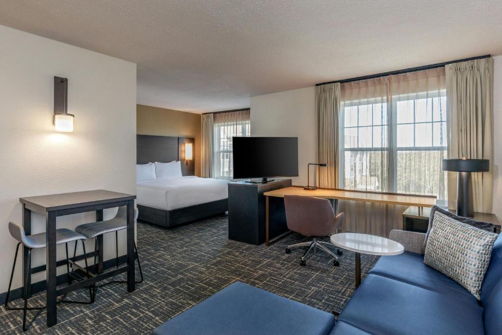 a hotel room with a bed and a desk at Residence Inn Worcester in Worcester