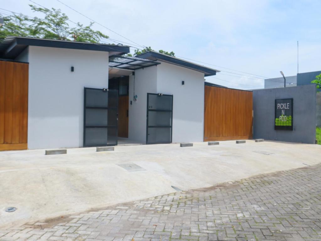 a rendering of a house with a courtyard at Pickle n Pod villa in Solo with pickle court near mall in Grogol
