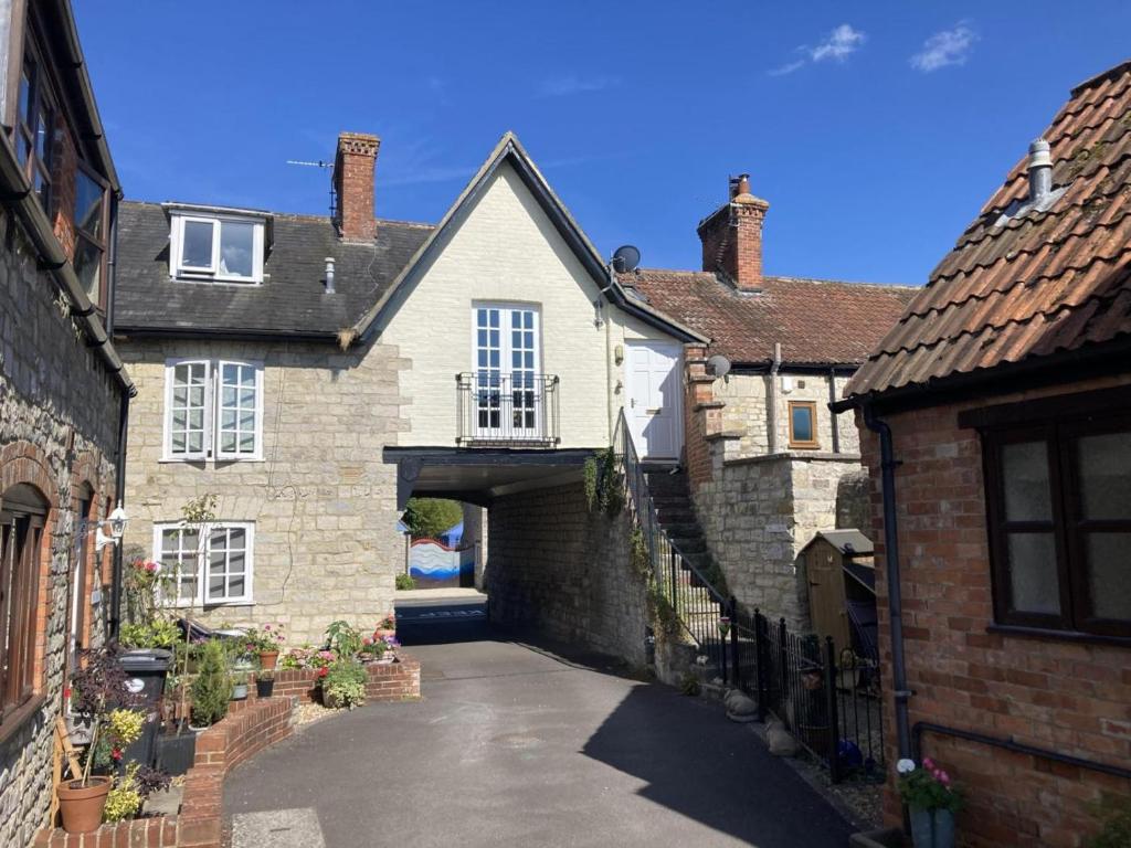 an alleyway between two old brick buildings at 1 Bed in Queen Camel oc-c30506 in Queen Camel