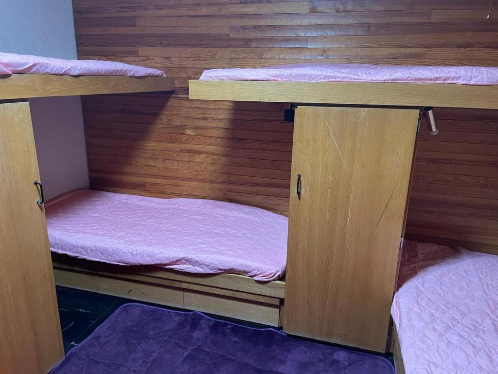 two bunk beds in a room with wooden walls at Mandala in Vars