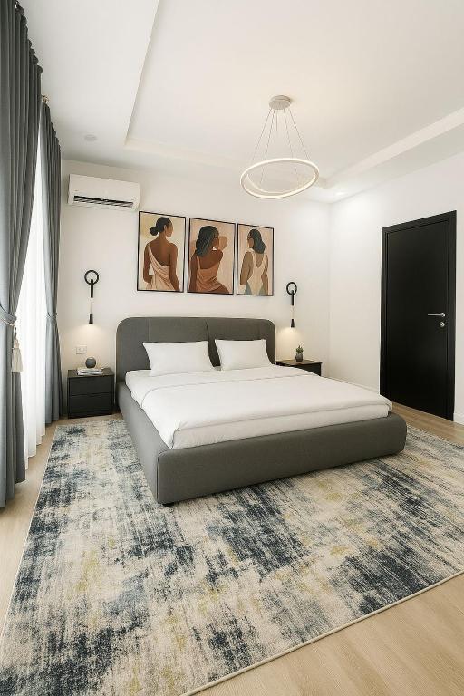 a bedroom with a large bed and a rug at Gift cozy 1 bedroom in Lekki