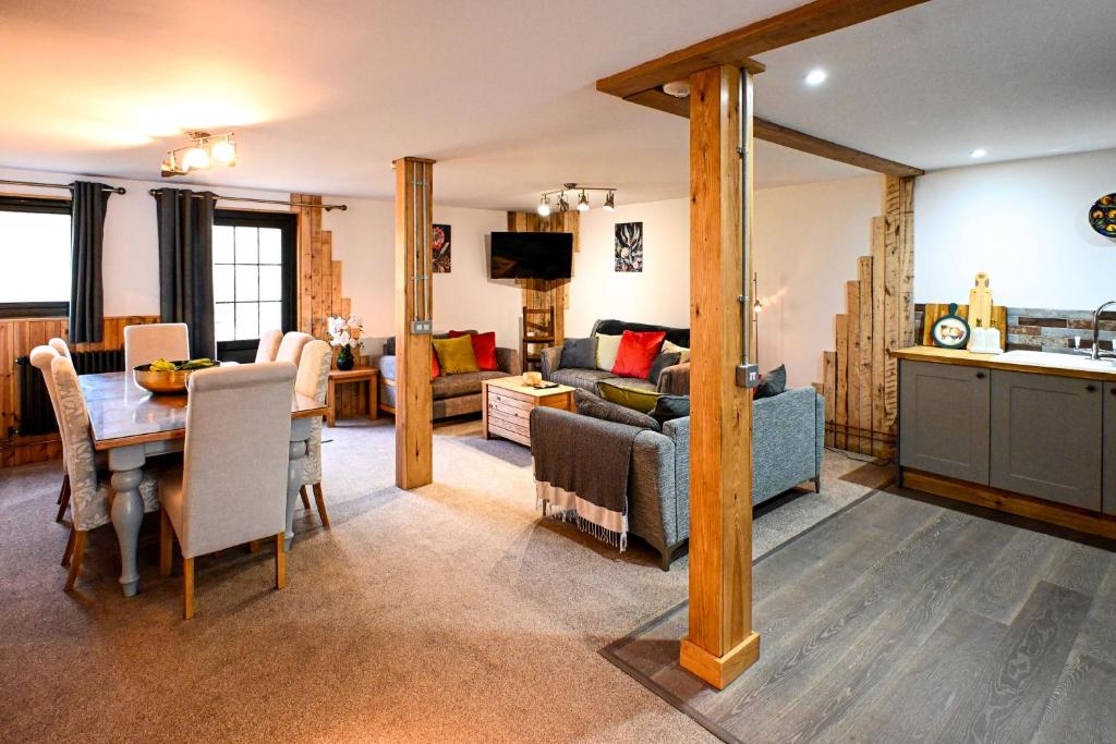 a living room with a table and a dining room at Eeyore's Place in Hythe