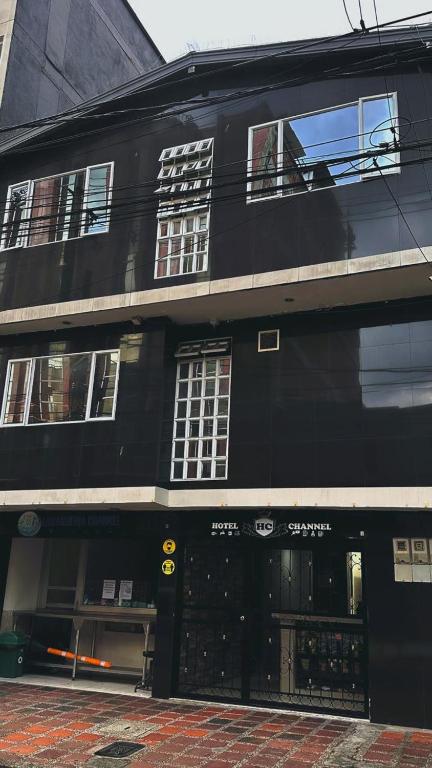 a black building on a city street with a store at hotel chanel in Itagüí