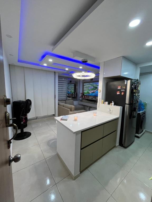 a kitchen with a white counter and a refrigerator at El encanto de Cartagena in Cartagena de Indias