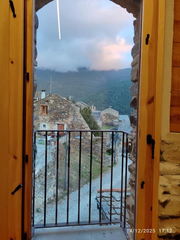 a view from the door of a room with a balcony at Cal RAFELÓ in Queralbs