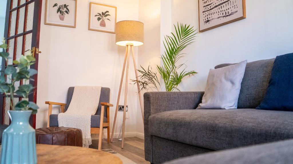 a living room with a couch and a table at 3BR House Near Cardiff Bay City Centre and Stadium with Free Parking in Cardiff