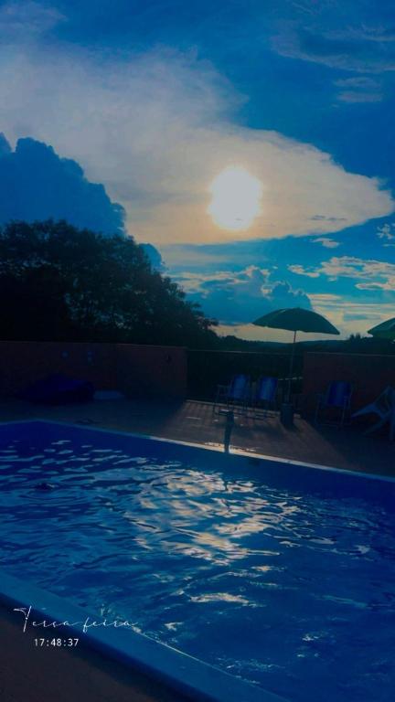 a view of a swimming pool at night at Chácara Anna Julia in Piedade