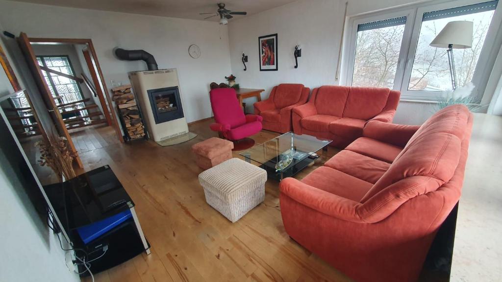 an aerial view of a living room with red furniture at Bergblick in Medebach