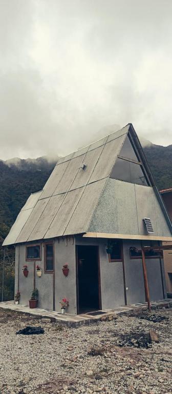 a small house with a roof on top of it at Raíces de Papallacta in Papallacta