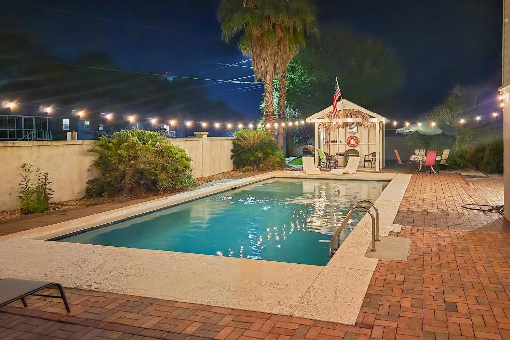 a swimming pool at night with a gazebo at Tybee Island Gem: Spacious Home w/ Private Pool in Tybee Island