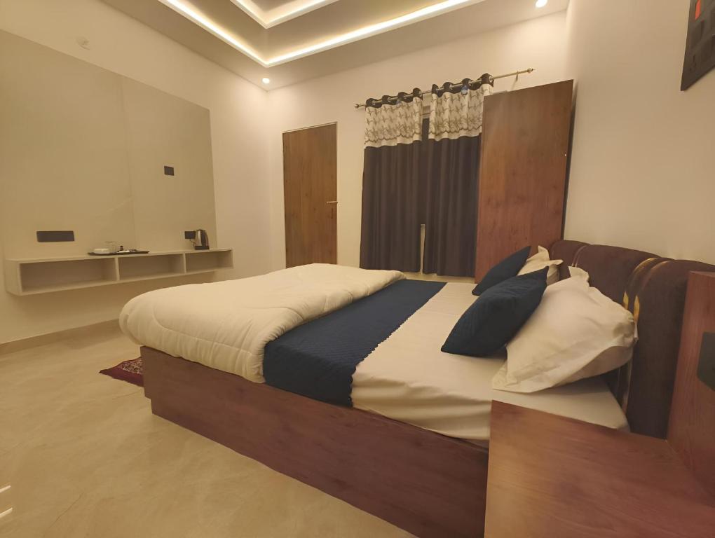 a bedroom with a large bed in a room at Arohan stay in Ayodhya