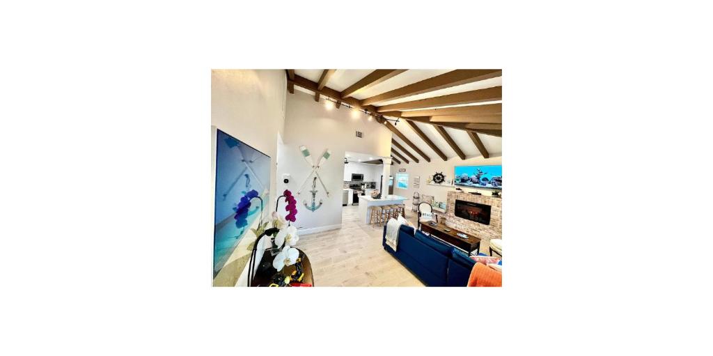 a living room with white walls and wooden ceilings at Shared Space in SoSo Coastal Retreat in West Palm Beach