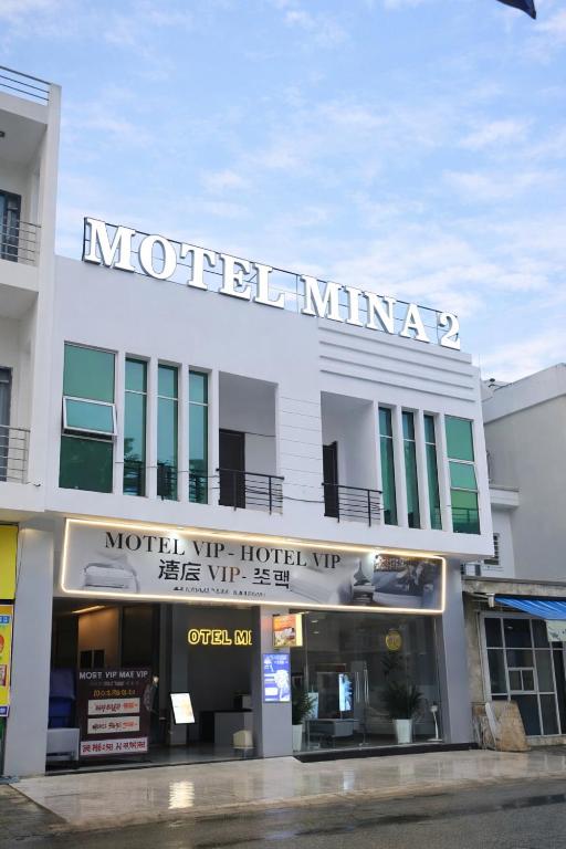 a building with a sign for a hotel at Mina Motel 2 in Thuan An