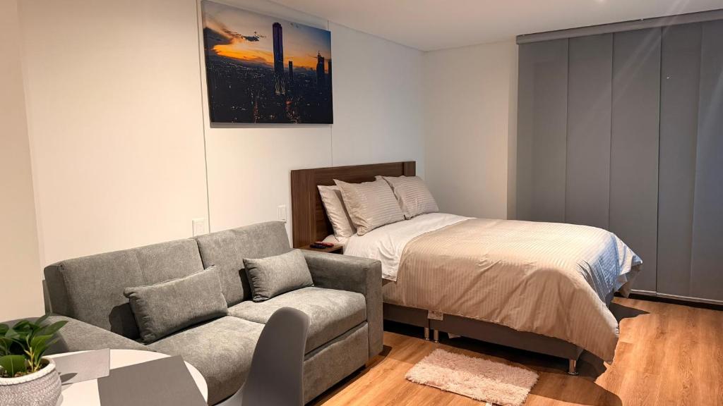 a living room with a couch and a bed at Teusaquillo Urban Loft in Bogotá