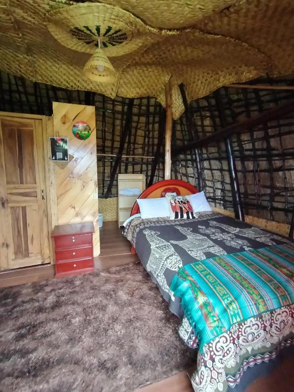 a bedroom with a bed in a yurt at COTOPAXI Wasi Andina Lodge in Latacunga
