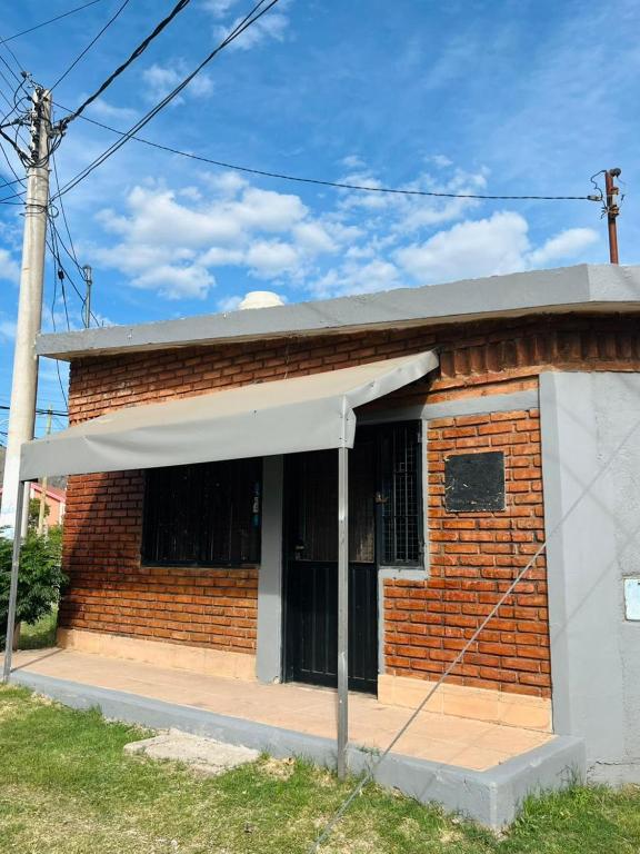 a red brick building with a white awning at El Resguardo in San Luis