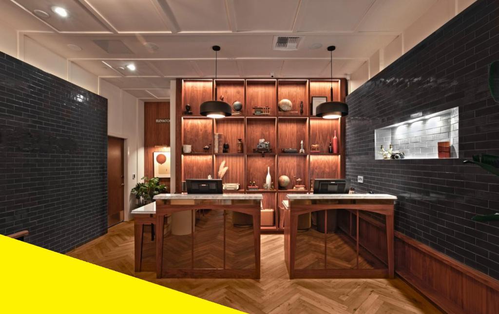 a kitchen with wooden cabinets and two tables at Bposhtels San Francisco in San Francisco