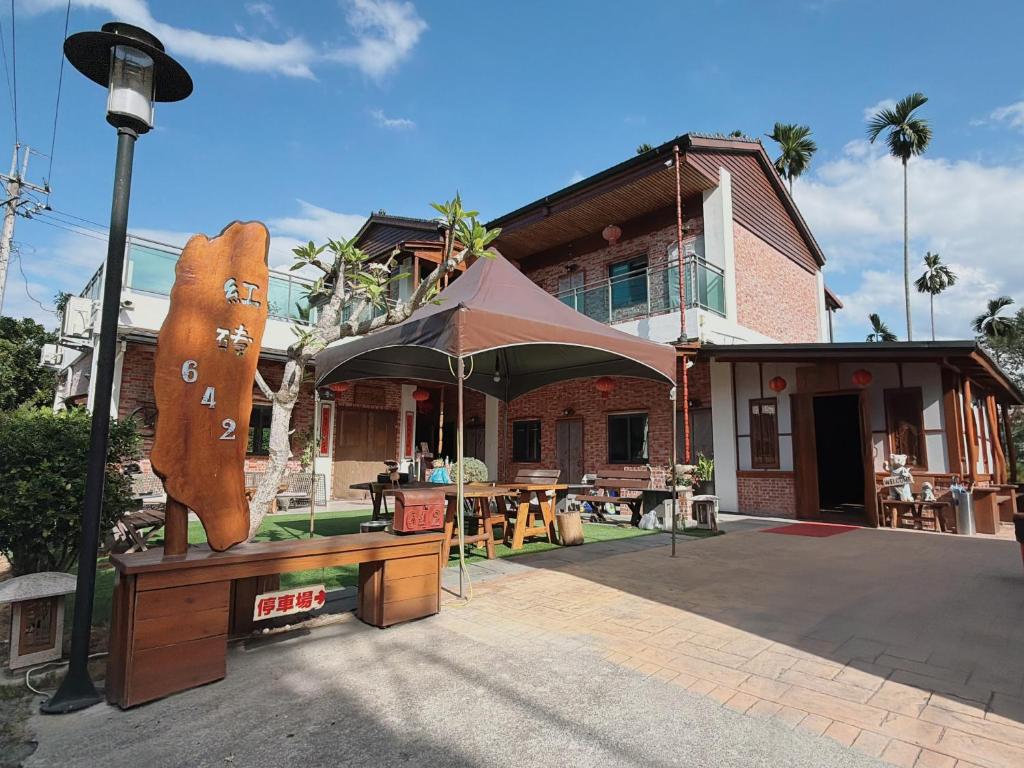 a building with a bear statue in front of it at Red brick 642 B&B in Puli