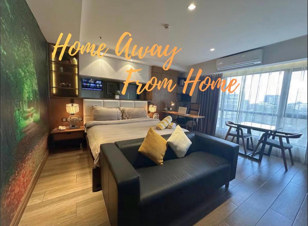 a home away from home bedroom with a bed and a couch at Centrally located Premium Studio in Angeles