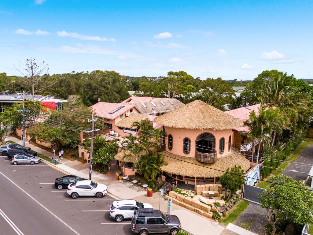 an aerial view of a house with cars parked on the street at Aquarius Backpackers Resort in Byron Bay