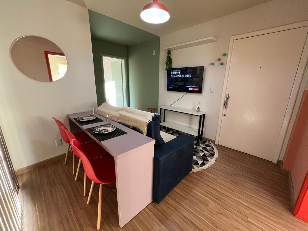 a small living room with a table and red chairs at Ed Las Vegas by Select Stays in Chapecó