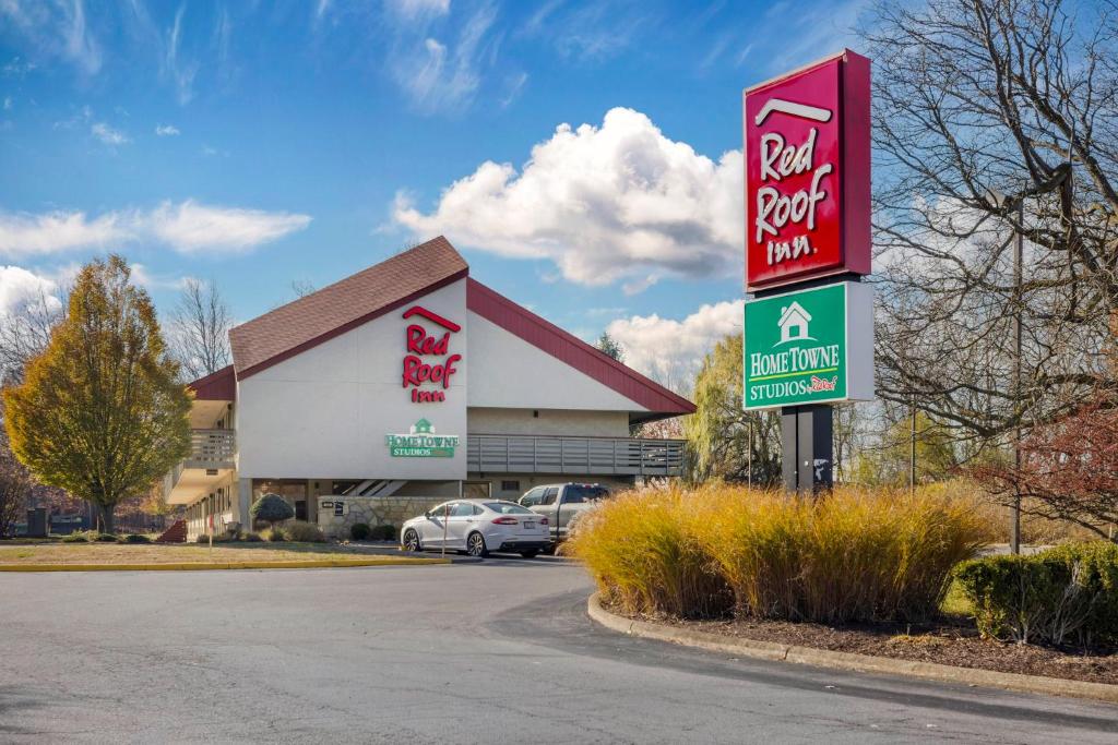 a sign for a fast food restaurant in a parking lot at HomeTowne Studios by Red Roof Buffalo - Niagara Airport in Williamsville