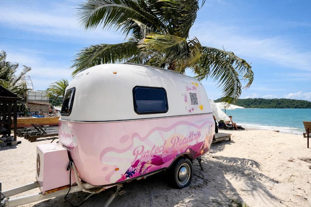 a pink and white trailer parked on the beach at Seaside Cenang in Pantai Cenang
