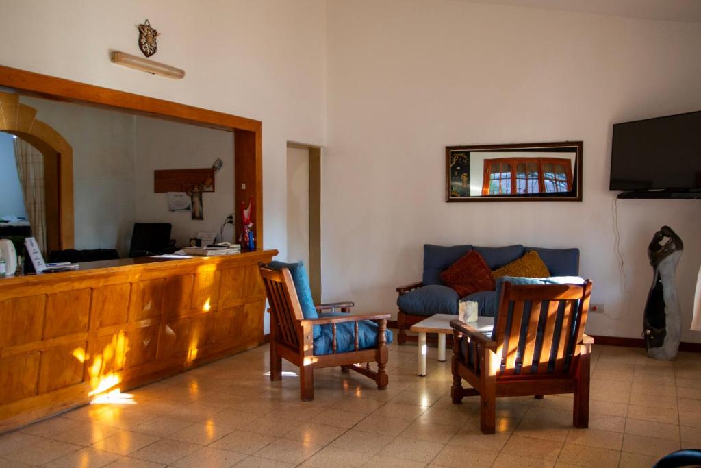 a living room with two chairs and a couch at Hotel Barcelona in General Alvear