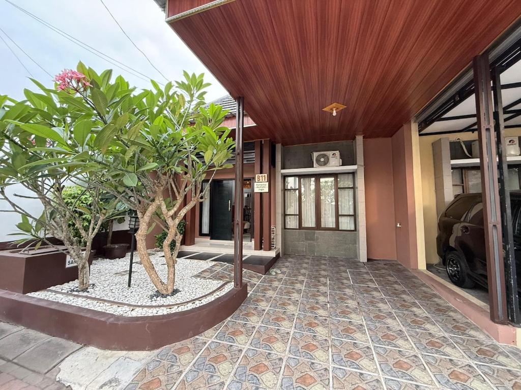 an entrance to a house with trees in front of it at Homestay Aesthetic Jogja in Gondowulung