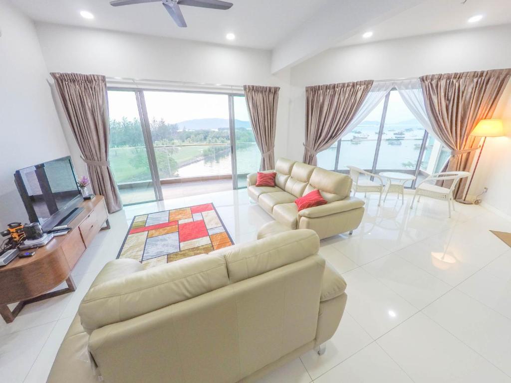 a living room with two couches and a television at Luxury Condominium at Loft Imago in Kota Kinabalu