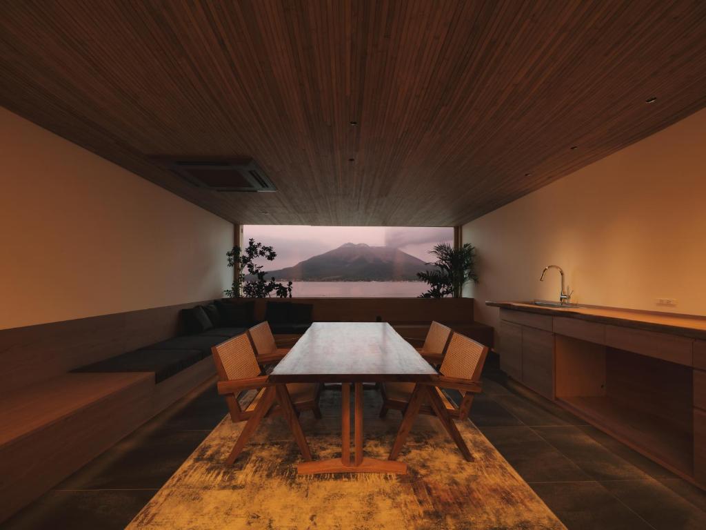 a dining room with a table and chairs at Good Fellows Resort in Kagoshima