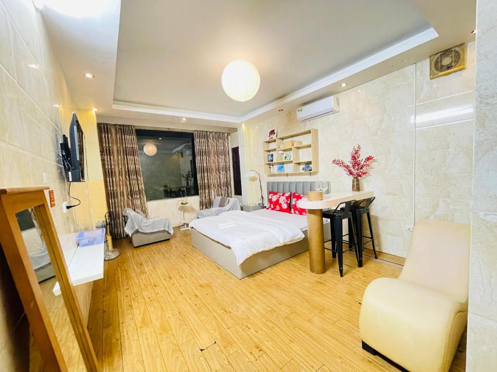a bedroom with a bed and a table and a chair at Duyen Motel in Hanoi